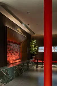 A modern restaurant interior featuring metal, wood, and marble elements.