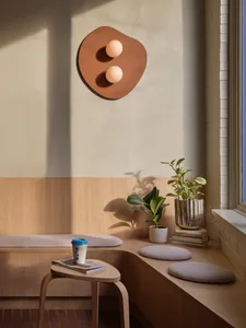 A modern retail storefront with a wooden exterior and a curved, cushioned seating area.