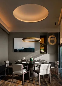 Modern dining room with wooden furniture, circular light fixture, and mountain art