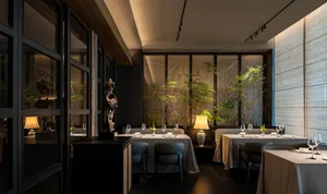A well-lit, contemporary restaurant interior with modern furnishings and decor, featuring sleek tables, chairs, and wall-moun