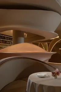 A modern restaurant interior with metallic architectural elements and futuristic design.