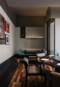 Modern restaurant interior featuring wooden furniture, glass decor, and marble accents