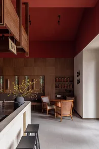 A modern restaurant interior with wooden walls and terrazzo flooring.
