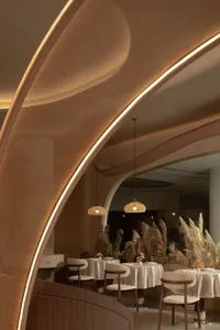 A modern restaurant interior with woven lighting fixtures and concrete elements.