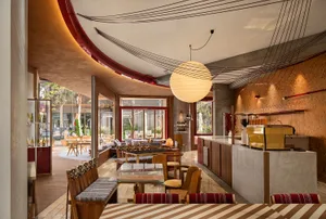 Contemporary cafe interior featuring wooden furnishings and a warm, inviting atmosphere.