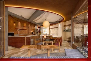 A modern restaurant interior featuring wooden furniture and a warm, inviting atmosphere.