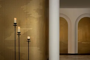 Three decorative candles on metal wall panels.