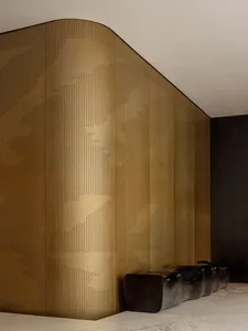 Modern lobby interior with a metallic, perforated wall panel