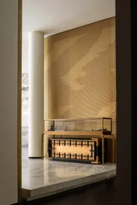 Modern retail storefront featuring a metallic display case with a glass top and bottom shelves.