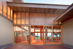 Modern exterior of a coffee shop with wooden elements.