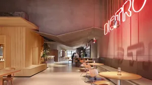 A modern restaurant interior with wood, concrete, and metal furnishings.