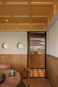 Modern restaurant interior with wooden materials and minimalistic design.