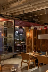 Interior of an industrial-style cafe with wooden tables and chairs
