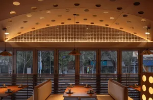 A modern restaurant interior featuring wooden materials.