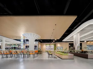 Modern cafeteria interior design with white flooring and minimalist furniture.
