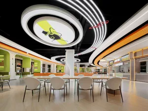 A spacious, modern eatery illuminated by neon lights.