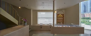Modern minimalist coffee shop interior with concrete materials and stylish decor.