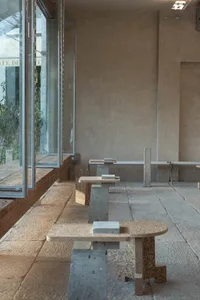 Minimalist modern interior space featuring concrete and terrazzo materials.