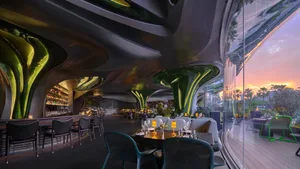 A modern restaurant with metallic decor features sleek, curved fixtures for contemporary dining experience.