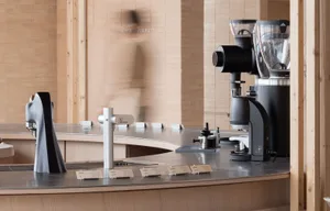 Modern coffee shop counter featuring a black metal design