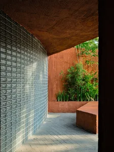 Modern outdoor space featuring glass blocks and red earth material