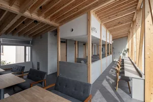 Interior design of a modern office space featuring wood and concrete materials.