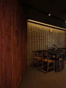 Modern restaurant interior featuring glass brick walls and wooden chairs