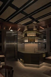 Interior of an industrial-themed restaurant bar featuring metal and wooden elements