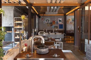 Industrial design restaurant interior with metal elements, glass, and concrete