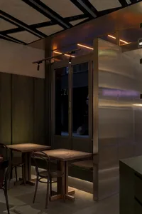 An industrial-style restaurant interior with a metal breakfast counter.