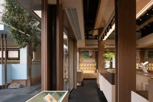 A modern retail storefront featuring wood and glass materials.