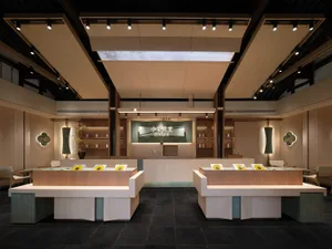 A modern coffee shop featuring wooden furniture and ceramic details.