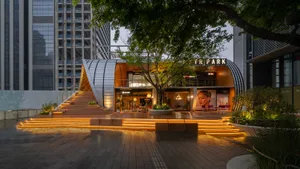 Modern storefront with metallic architectural elements and illuminated signage.