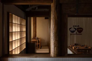 A photograph of a wooden-restaurant interior with soft lighting.