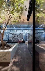 A minimalist modern office lounge featuring glass planters.