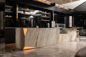 An industrial-style coffee shop with a marble counter.