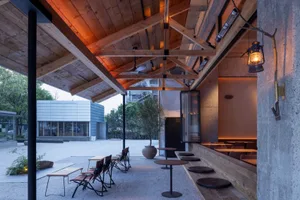 An indoor restaurant with wooden elements and a rustic atmosphere.