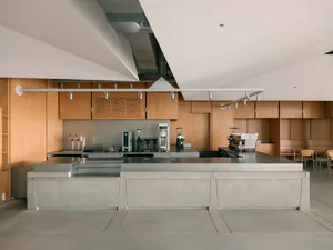 Minimalist coffee shop interior with concrete flooring and minimalist design elements.
