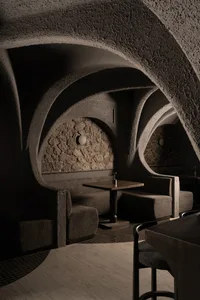 Industrial-style restaurant interior with concrete walls and seating