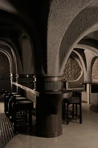 A modern bar with a concrete wax counter and seating