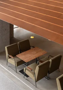 A modern cafe interior featuring concrete and steel elements.
