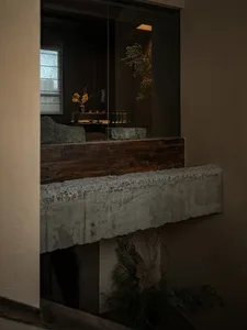 A modern living space with concrete walls and a wooden beam