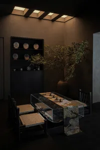 A modern tea room featuring wood furniture and a table with cups and saucers.