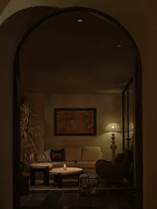 A cozy living room with soft, comfortable furniture and warm lighting.