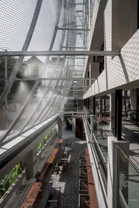 Interior design of a modern cafeteria with glass walls and concrete flooring.