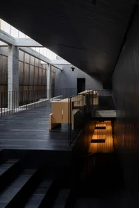 Modern interior space featuring concrete and wooden elements.