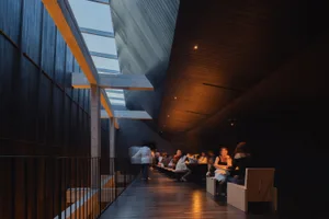 Interior of a modern restaurant featuring concrete and wooden elements