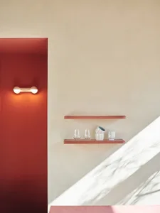 A minimalist interior design featuring ceramic shelves with glassware and ceramic cups.