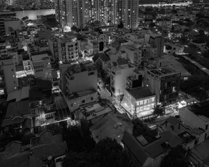 Nighttime cityscape view with modern buildings featuring concrete, glass, and steel.