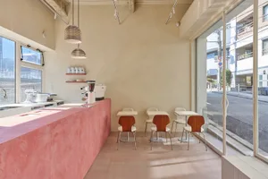 A minimalist cafe with concrete finishes and glass windows